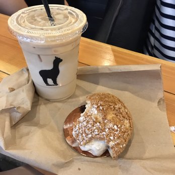 Bibble & Sip - Iced lavender latte and partially eaten earl grey cream puff - Coffee & Tea Near Me - New York, New York