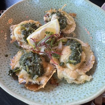 Lucuma Kitchen and Bar - Conchitas a la Parmesana- baked scallops with chimichurri and cheese - Peruvian Near Me - Oakland, California Lucuma Kitchen and Bar - Conchitas a la Parmesana- baked scallops with chimichurri and cheese - Peruvian Near Me - Oakland, California