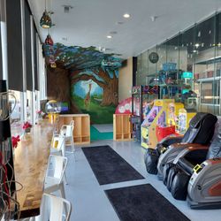 The Wash House And Cafe - Phone chargers, stools with a view of the parking lot, children's play area, games and toy dispensers, and massage chairs.