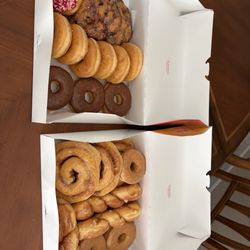 Apple fritter, pink sprinkles, raised glazed, chocolate raised, maple raised, cinnamon rolls, and twists