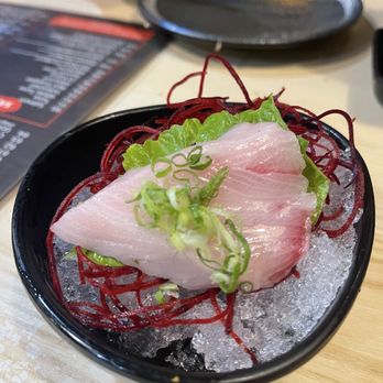 Sake - A slice of Yellowtail (Hamachi) Sashimi (nicely presented) - Sushi Bars Near Me - Pinole, California