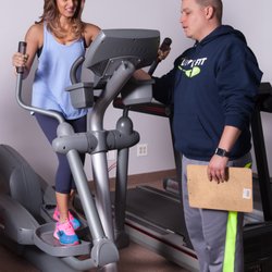 Live Fit Personal Training + Nutrition - Trainer Mark helping Mona determine the optimum speed and resistance for her cardio interval.