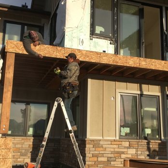 MITM - a man on a ladder working on a house - General Contractors Near Me MITM - a man on a ladder working on a house - General Contractors Near Me
