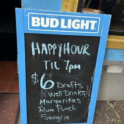Dominie's - Fake happy hour sign - margaritas, rum punch, drafts, and sangria are not included. Only well drinks with less than $3 ingredients.