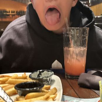 LongHorn Steakhouse - Man enjoying his food Chicken Tenders - Steakhouses Near Me - Castleton, Indiana