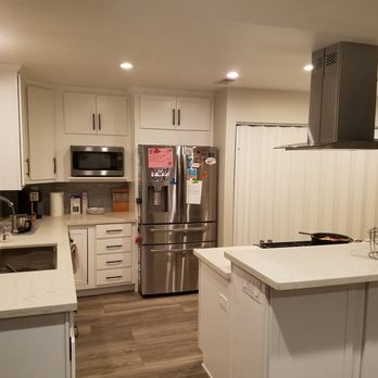 Premier Contracting - a kitchen with white cabinets and stainless steel appliances - General Contractors Near Me - Yorba Linda, California
