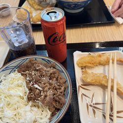 Teriyaki beef rice bowl. Not much beef but tons of rice. Got 2 shrimp tempura on the way.