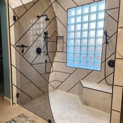 Best Choice Glass & Railing - Modern frameless glass shower door with bronze glass in a Vancouver bathroom with sleek black hardware