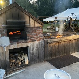 Pizza oven and grill out near the seating area. Pizza oven and grill out near the seating area.
