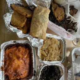 Griot pork platter, djon djon side, green plantains, Haitian mac, cabbage, chicken & codfish patties