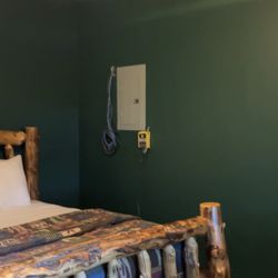 Gateway Lodge and Resort - FIRE/SAFETY HAZARD - wires hanging down loose out of wall near breaker box - IN BEDROOM OF HONEYMOON CABIN