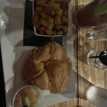 Wheelhouse Downtown - Breakfast sandwich with breakfast potatoes and small side of fruit - Burgers Near Me - Saint Louis, Missouri Wheelhouse Downtown - Breakfast sandwich with breakfast potatoes and small side of fruit - Burgers Near Me - Saint Louis, Missouri