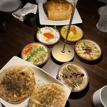 Anixi - Dips (taramasalata, roasted eggplant, ful medames, hummus, whipped ricotta) with layered herb bread and zaatar pita - Vegan Near Me - New York, New York Anixi - Dips (taramasalata, roasted eggplant, ful medames, hummus, whipped ricotta) with layered herb bread and zaatar pita - Vegan Near Me - New York, New York