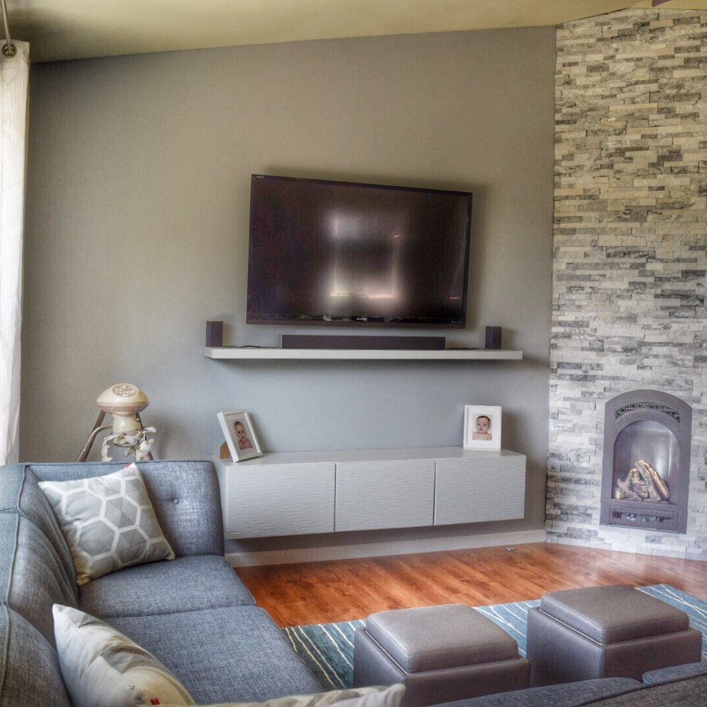 Finish Cuts Construction - a living room with a fireplace - General Contractors Near Me Finish Cuts Construction - a living room with a fireplace - General Contractors Near Me