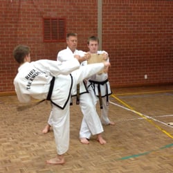 Rhee Tae Kwon-Do - CKJN Aaron Abell and Sabum Josh demonstrating a turning-kick board break.