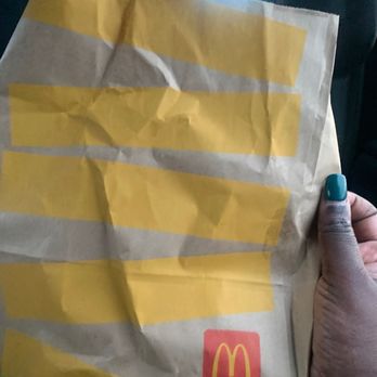 McDonald's - a hand holding a bag of food - Burgers Near Me - Byron, Georgia