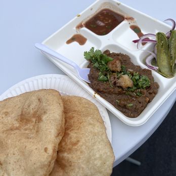 Spicy Tandoor - a plate of food and a container of pickles - Indian Near Me - Sunnyvale, California