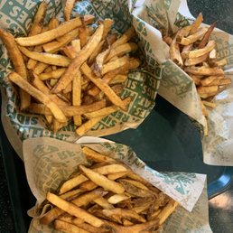 two baskets of french fries on a tray two baskets of french fries on a tray