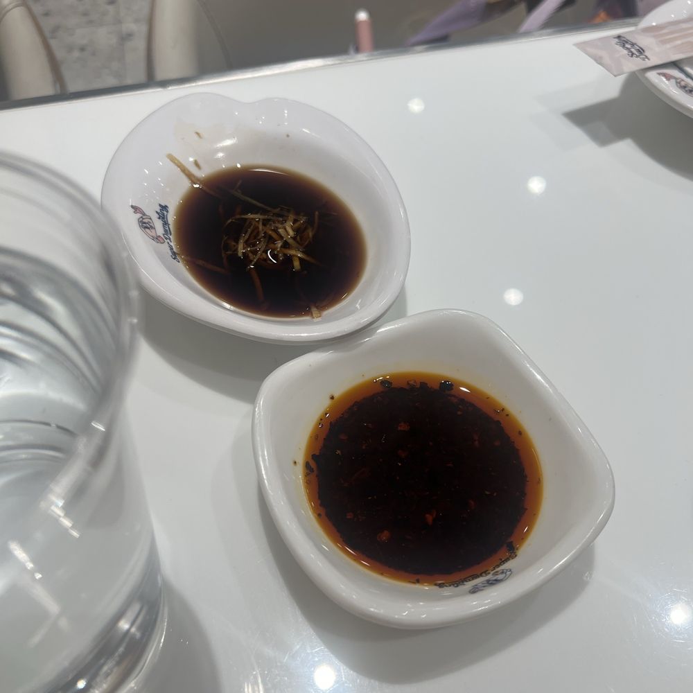 Super Dumpling - Sauces that come immediately to your table. One is a black vinegar and the other is a chili oil - Noodles Near Me - Orange, California