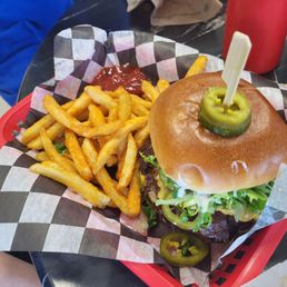Stacked Burger with jalapenos and seasoned fries. Stacked Burger with jalapenos and seasoned fries.