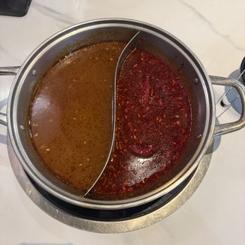 Shabu Shack - Left side: Tom Yum broth Right side: Spicy Sichuan broth - Japanese Near Me - Davis, California Shabu Shack - Left side: Tom Yum broth Right side: Spicy Sichuan broth - Japanese Near Me - Davis, California