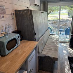 Murphy bed converts to a cushioned bench in Container #2.