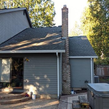 Skyline Roofing - The rear of the house with brand new white aluminum gutters. Also you can see the  repaired step flashing, where the roof meets the siding - Roofing Near Me