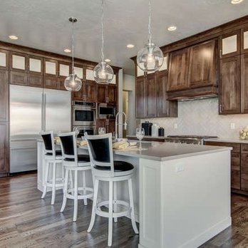 Huntwood - a kitchen with a center island and bar stools - Cabinetry Near Me - Boise, Idaho Huntwood - a kitchen with a center island and bar stools - Cabinetry Near Me - Boise, Idaho