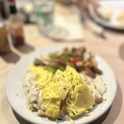 Wilma & Frieda's - CHEF CHAD'S BISCUITS & GRAVY*: house-made biscuit, topped w/sausage & pecan wood bacon gravy, two eggs & house potatoes | $19.5