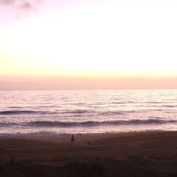 The Hennessy’s House - Me sitting on the beach drinking coffee in pure bliss at the November retreat.