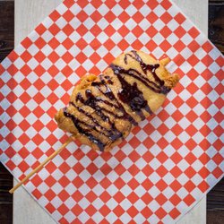 Meat Kandy Food Truck - The famous MINI MONSTER
a Frosted cinnamon bun and an extra large marshmallow battered deep fried & drizzled with chocolate fudge/powder