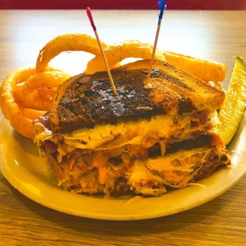 Antique Row Cafe - Reuben on toasted marbled rye, onion rings and pickle spear ..looks better than it tastes :( - American Near Me - San Diego, California Antique Row Cafe - Reuben on toasted marbled rye, onion rings and pickle spear ..looks better than it tastes :( - American Near Me - San Diego, California
