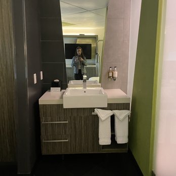 The Moment Hotel - a woman taking a selfie in the bathroom mirror - Hotels Near Me - Los Angeles, California The Moment Hotel - a woman taking a selfie in the bathroom mirror - Hotels Near Me - Los Angeles, California