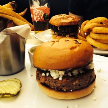 Square One Bar & Grill - Veggie burger with goat cheese and pesto and in the back the peppercorn burger with fried onions - New American Near Me - Danbury, Connecticut Square One Bar & Grill - Veggie burger with goat cheese and pesto and in the back the peppercorn burger with fried onions - New American Near Me - Danbury, Connecticut