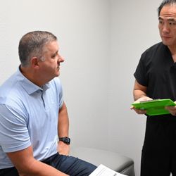 Southlake Physical Medicine - Dr Chen consulting with a patient