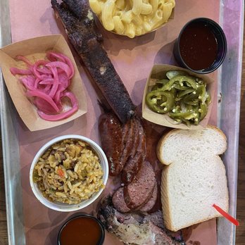 The Pit Room - Memorial - BBQ with 3 meats. Brisket, Beef sausage, and ribs Slice of bread, side of rice, side of Mac and cheese. Radish and jalapeños - Barbeque Near Me - Houston, Texas The Pit Room - Memorial - BBQ with 3 meats. Brisket, Beef sausage, and ribs Slice of bread, side of rice, side of Mac and cheese. Radish and jalapeños - Barbeque Near Me - Houston, Texas