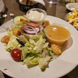 Lion's Den Restaurant - Side salad with ranch and Italian dressings.