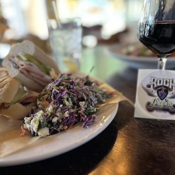 RocknGrapes - Turkey Bam Brie Lam and Fig Jam sandwich with a side of kale slaw and a glass of Chronic Cellars Purple Paradise. - Wine Bars Near Me - Henderson, Nevada RocknGrapes - Turkey Bam Brie Lam and Fig Jam sandwich with a side of kale slaw and a glass of Chronic Cellars Purple Paradise. - Wine Bars Near Me - Henderson, Nevada