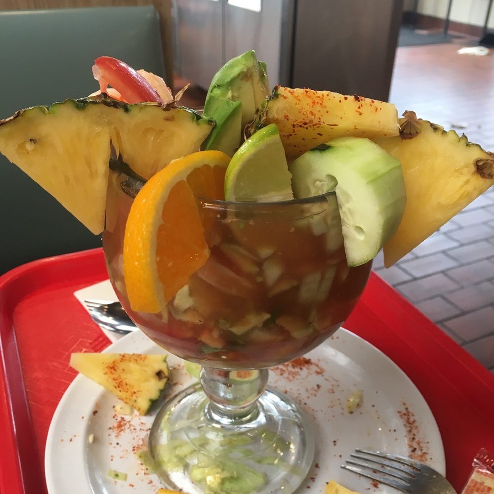 a tropical drink with a slice of orange and cucumber a tropical drink with a slice of orange and cucumber