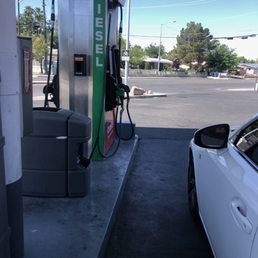 a gas pump and a car at a gas station