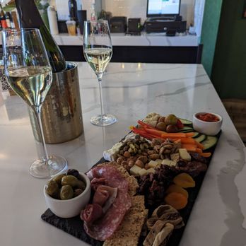 RBF, Your Authentic Champagne Bar - The Suit charcuterie board and a bottle of Cava. - Wine Bars Near Me - Cary, North Carolina RBF, Your Authentic Champagne Bar - The Suit charcuterie board and a bottle of Cava. - Wine Bars Near Me - Cary, North Carolina