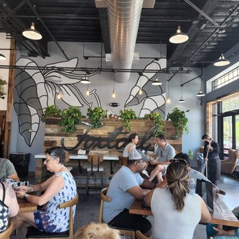 Foxtail Coffee - a group of people sitting at tables - Coffee Roasteries Near Me - Winter Garden, Florida