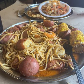 Red Crab - Juicy Seafood - Snowcrab and sausage with noodles - Seafood Near Me - Jensen Beach, Florida Red Crab - Juicy Seafood - Snowcrab and sausage with noodles - Seafood Near Me - Jensen Beach, Florida