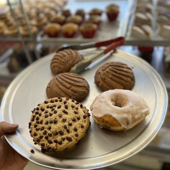 La Estrella - a person holding a plate of doughnuts - Bakeries Near Me - Chicago, Illinois
