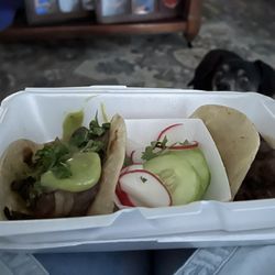 El Herradero Carniceria Cocina Y Tacos - 2 prime rib taco's on flour tortillas. With a hungry dog looking on hoping I will drop something. ;-)