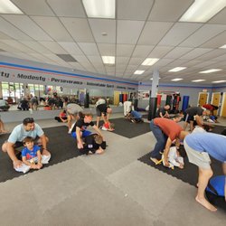 Karate International of West Raleigh - Father's working with their student children during a Father's Day class.