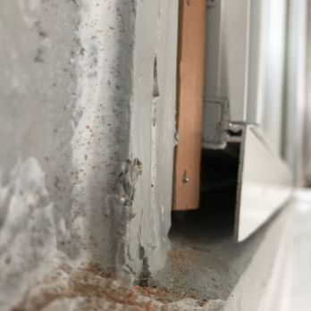 The Window Specialist - Wood filler missing behind the lower horizontal metal piece. Verticle wood piece cut to short. - Windows Installation Near Me