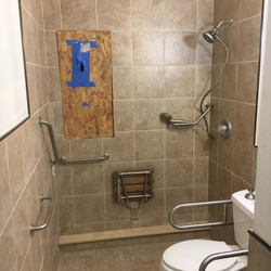 Carroll Construction - handicap bathrooms tile work, seat and hand bars.