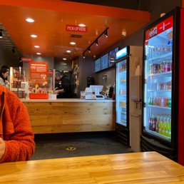 a woman sitting at a table in a fast food restaurant a woman sitting at a table in a fast food restaurant