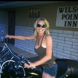 a woman sitting on a motorcycle a woman sitting on a motorcycle